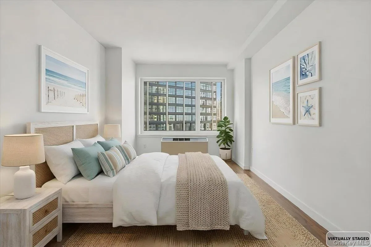 Bedroom featuring wood finished floors and radiator heating unit Bedroom featuring wood finished floors and radiator heating unit