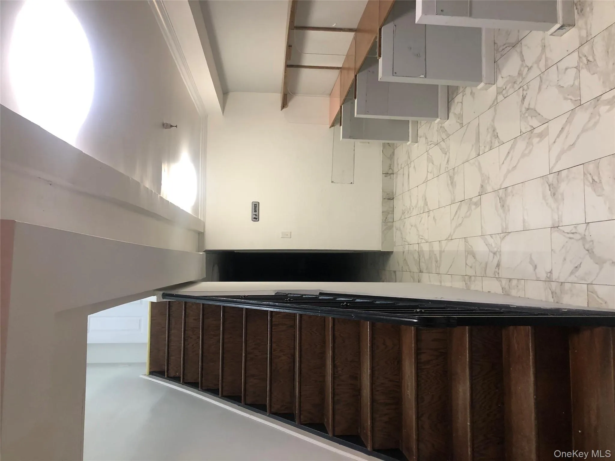 Staircase featuring marble finish flooring and baseboards Staircase featuring marble finish flooring and baseboards