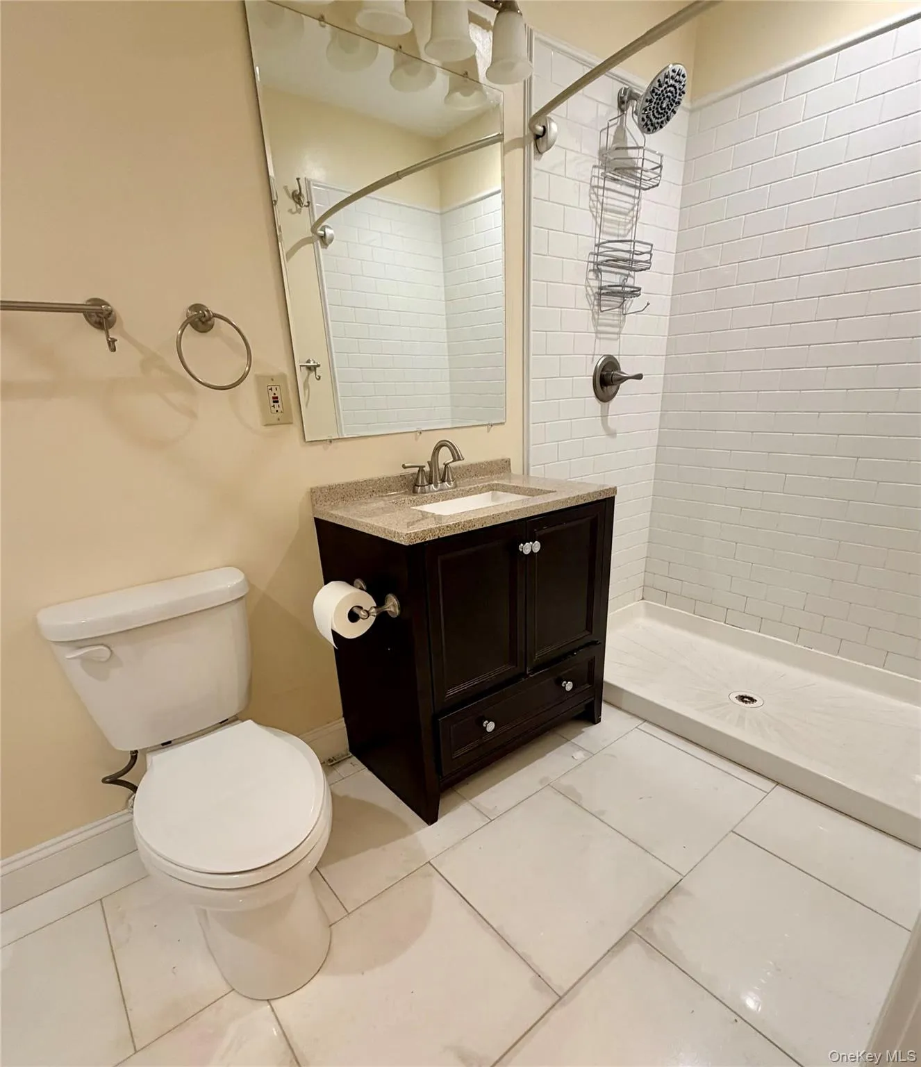 Full bathroom with vanity, a shower stall, and light tile patterned flooring Full bathroom with vanity, a shower stall, and light tile patterned flooring