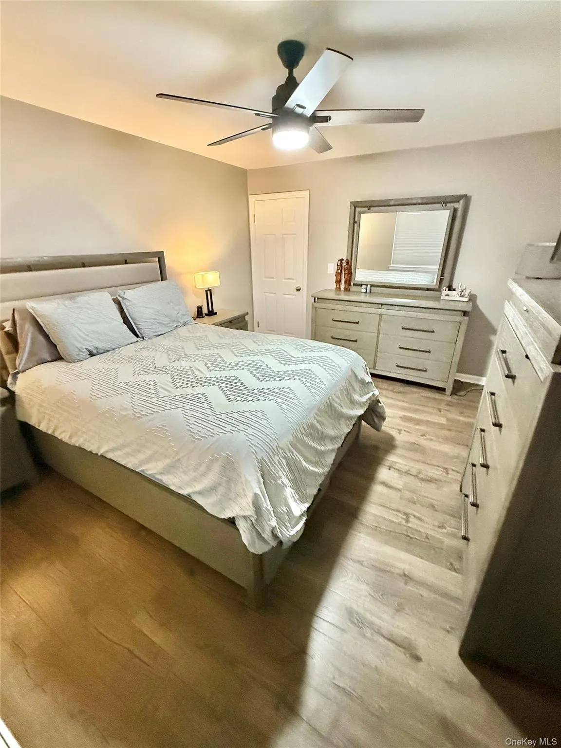 Bedroom with light wood-style flooring and ceiling fan Bedroom with light wood-style flooring and ceiling fan