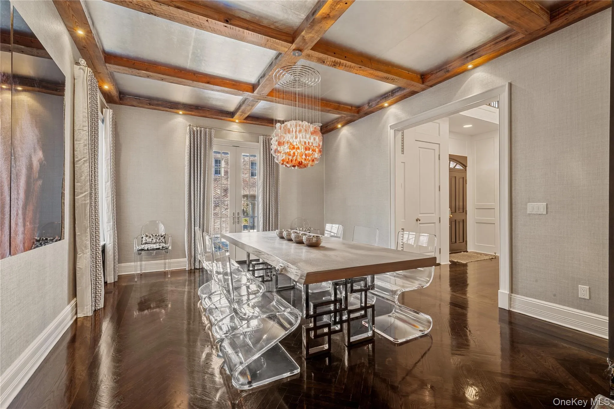 Dining space featuring coffered ceiling, beam ceiling, and a chandelier Dining space featuring coffered ceiling, beam ceiling, and a chandelier