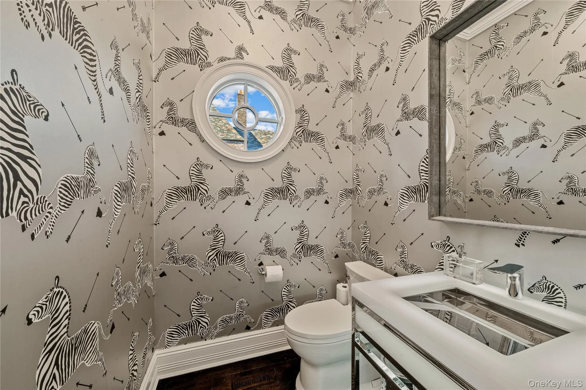 Half bath with toilet and dark wood-type flooring Half bath with toilet and dark wood-type flooring