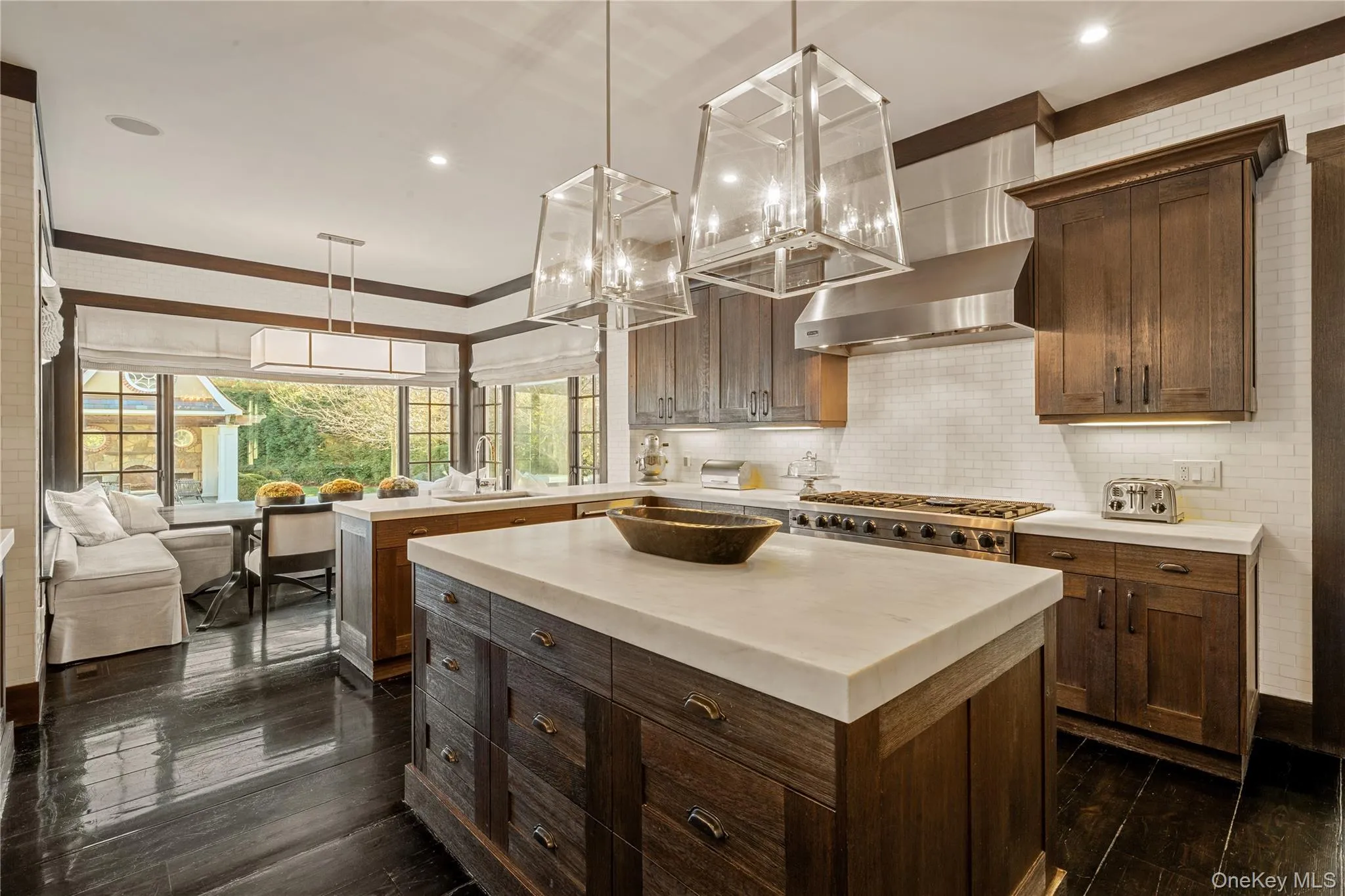 Kitchen featuring a kitchen island, dark brown cabinetry, wall chimney exhaust hood, recessed lighting, and pendant lighting Kitchen featuring a kitchen island, dark brown cabinetry, wall chimney exhaust hood, recessed lighting, and pendant lighting