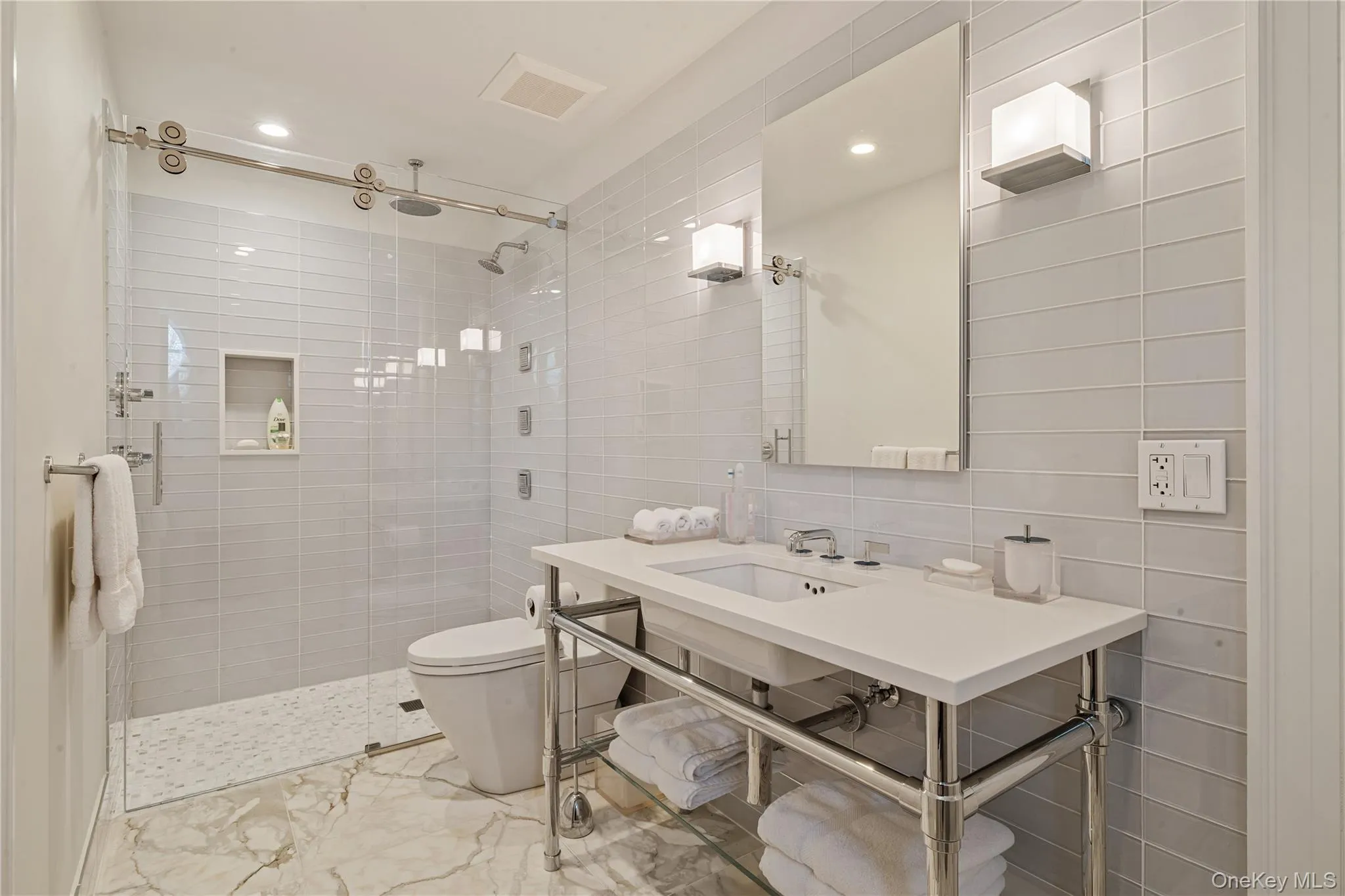 Full bath with light marble finish flooring, tile walls, a shower stall, and recessed lighting Full bath with light marble finish flooring, tile walls, a shower stall, and recessed lighting