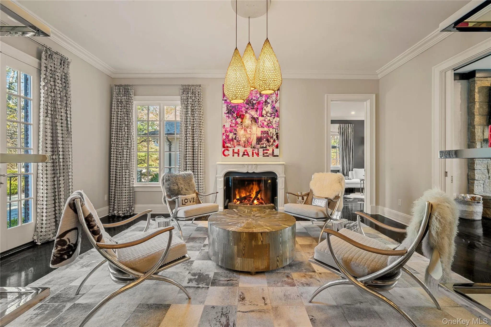 Sitting room with a premium fireplace, plenty of natural light, and crown molding Sitting room with a premium fireplace, plenty of natural light, and crown molding