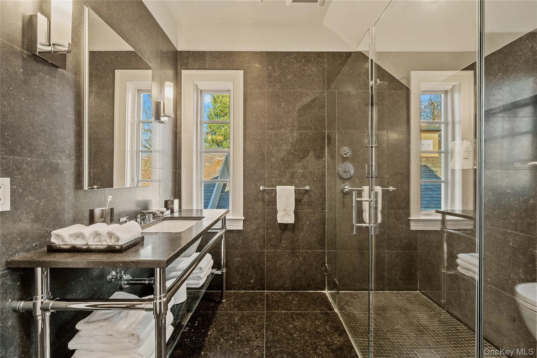 Full bath with a shower stall, vanity, and tile walls Full bath with a shower stall, vanity, and tile walls