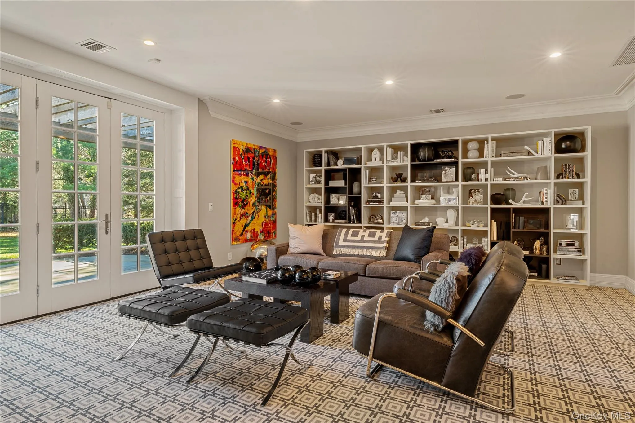 Carpeted living area featuring recessed lighting, french doors, and ornamental molding Carpeted living area featuring recessed lighting, french doors, and ornamental molding