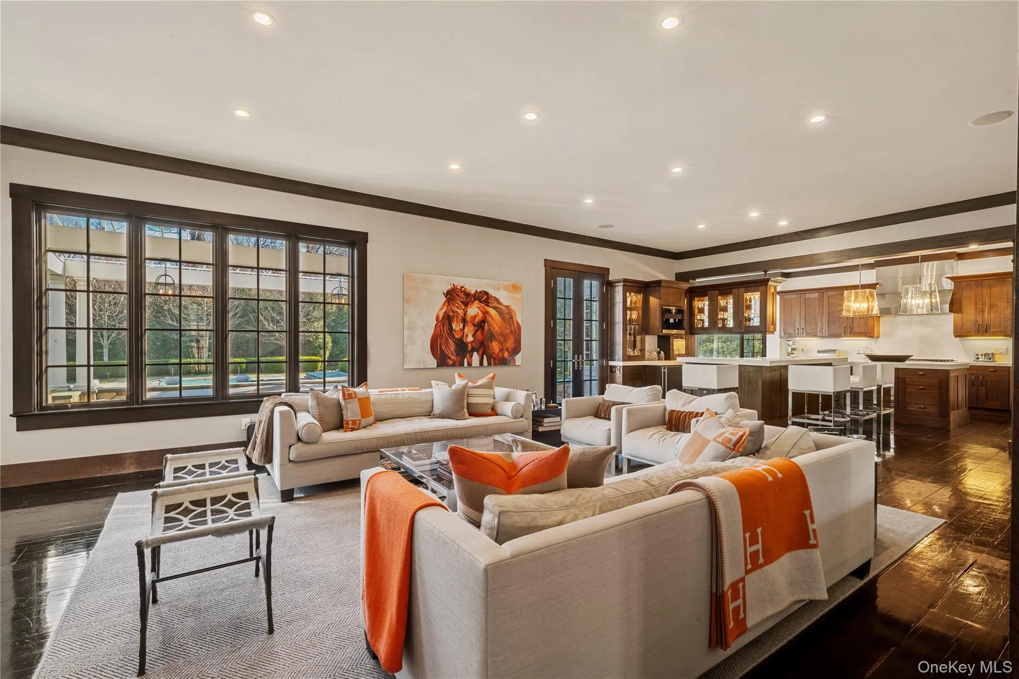 Living room with dark wood-style flooring, recessed lighting, and crown molding Living room with dark wood-style flooring, recessed lighting, and crown molding