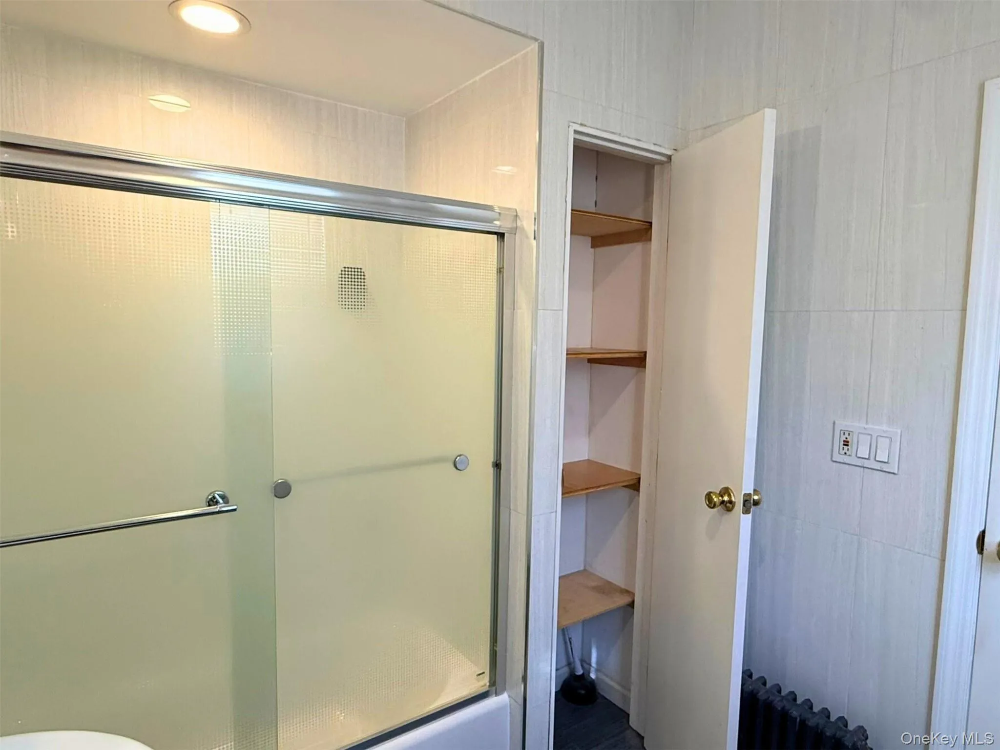 Full bathroom featuring a shower with shower door Full bathroom featuring a shower with shower door