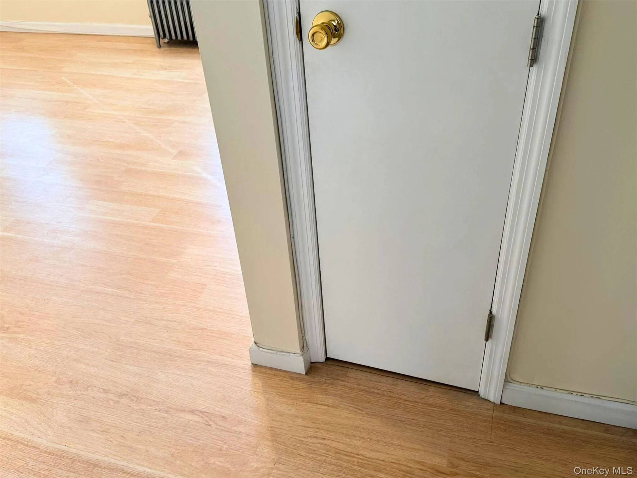 Detailed view of wood finished floors and radiator Detailed view of wood finished floors and radiator