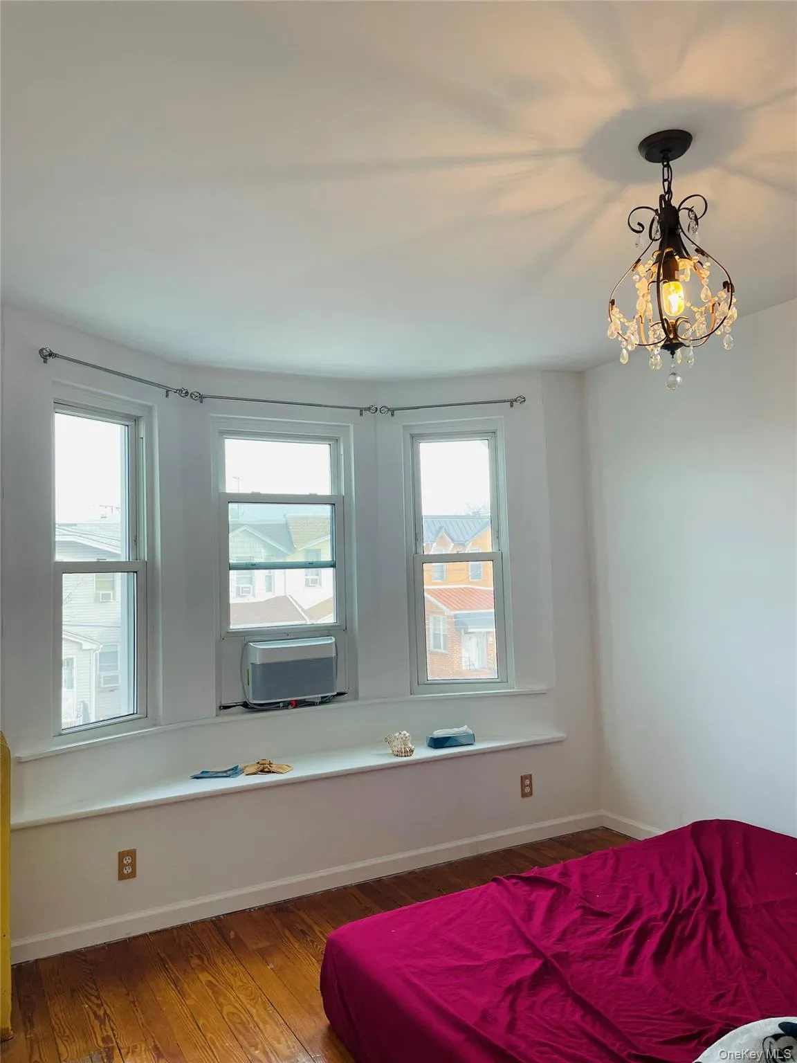 Bedroom with hardwood / wood-style flooring and a chandelier Bedroom with hardwood / wood-style flooring and a chandelier