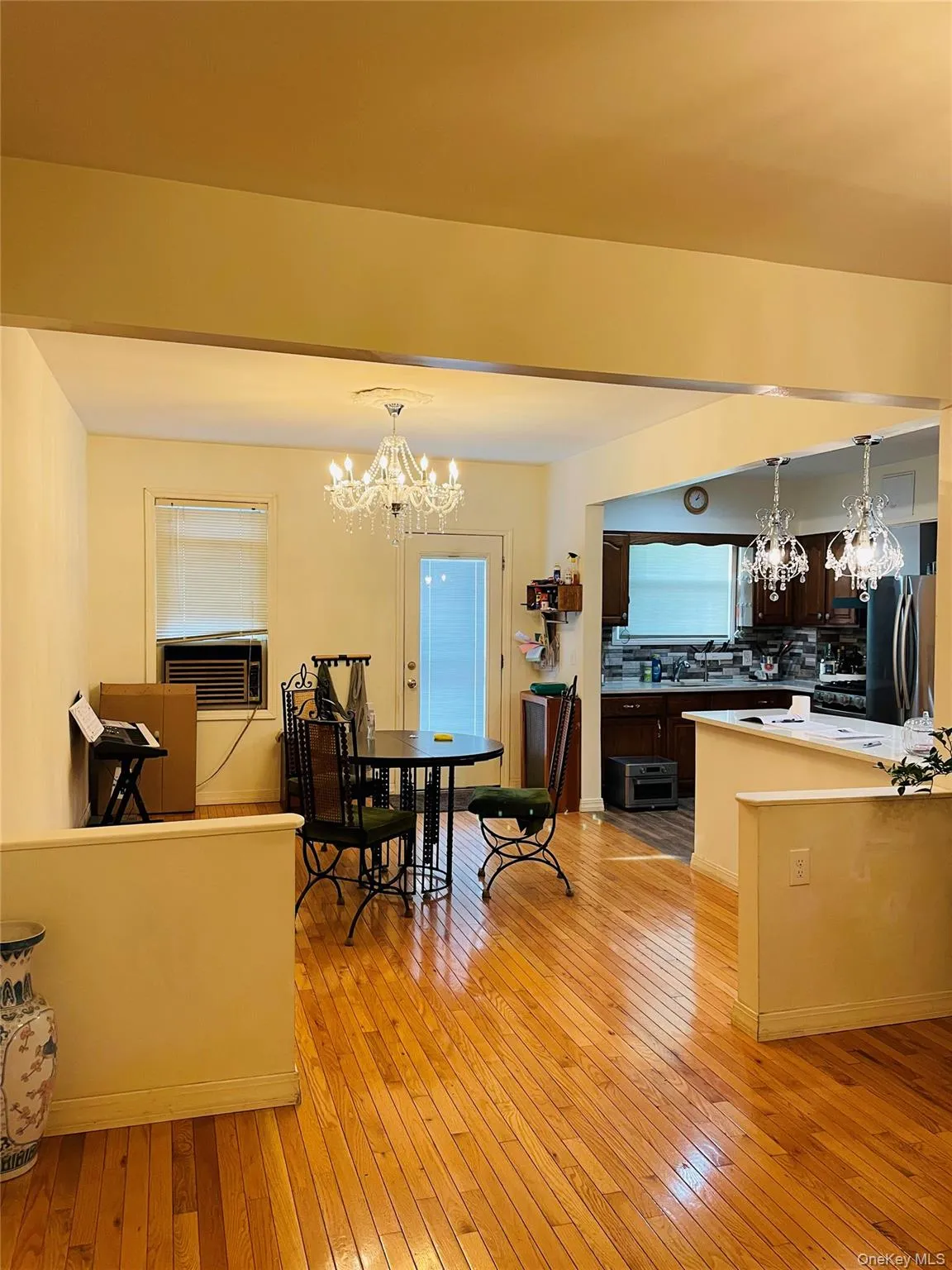 Dining space with a chandelier and light wood finished floors Dining space with a chandelier and light wood finished floors
