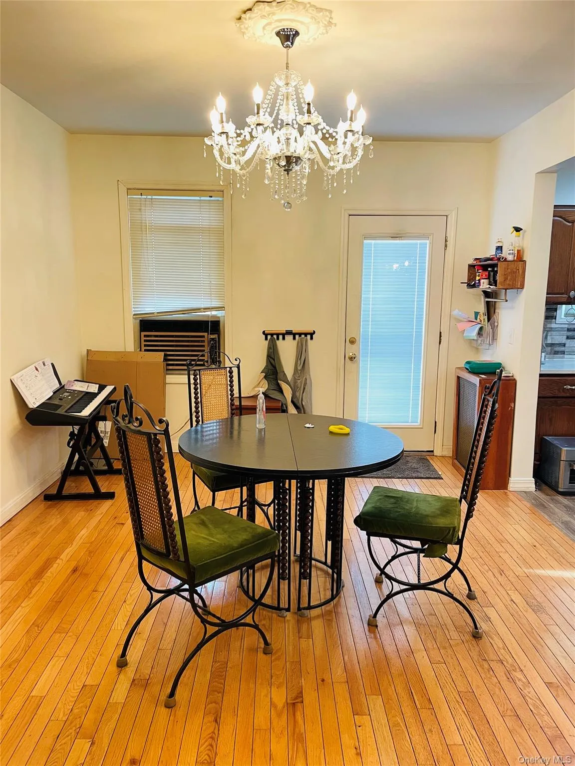 Dining space with light wood-type flooring and a chandelier Dining space with light wood-type flooring and a chandelier