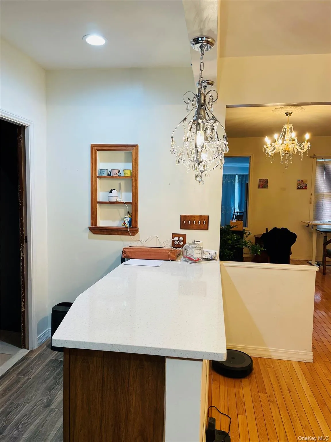 Kitchen with a breakfast bar area, dark wood finished floors, hanging light fixtures, a peninsula, and recessed lighting Kitchen with a breakfast bar area, dark wood finished floors, hanging light fixtures, a peninsula, and recessed lighting