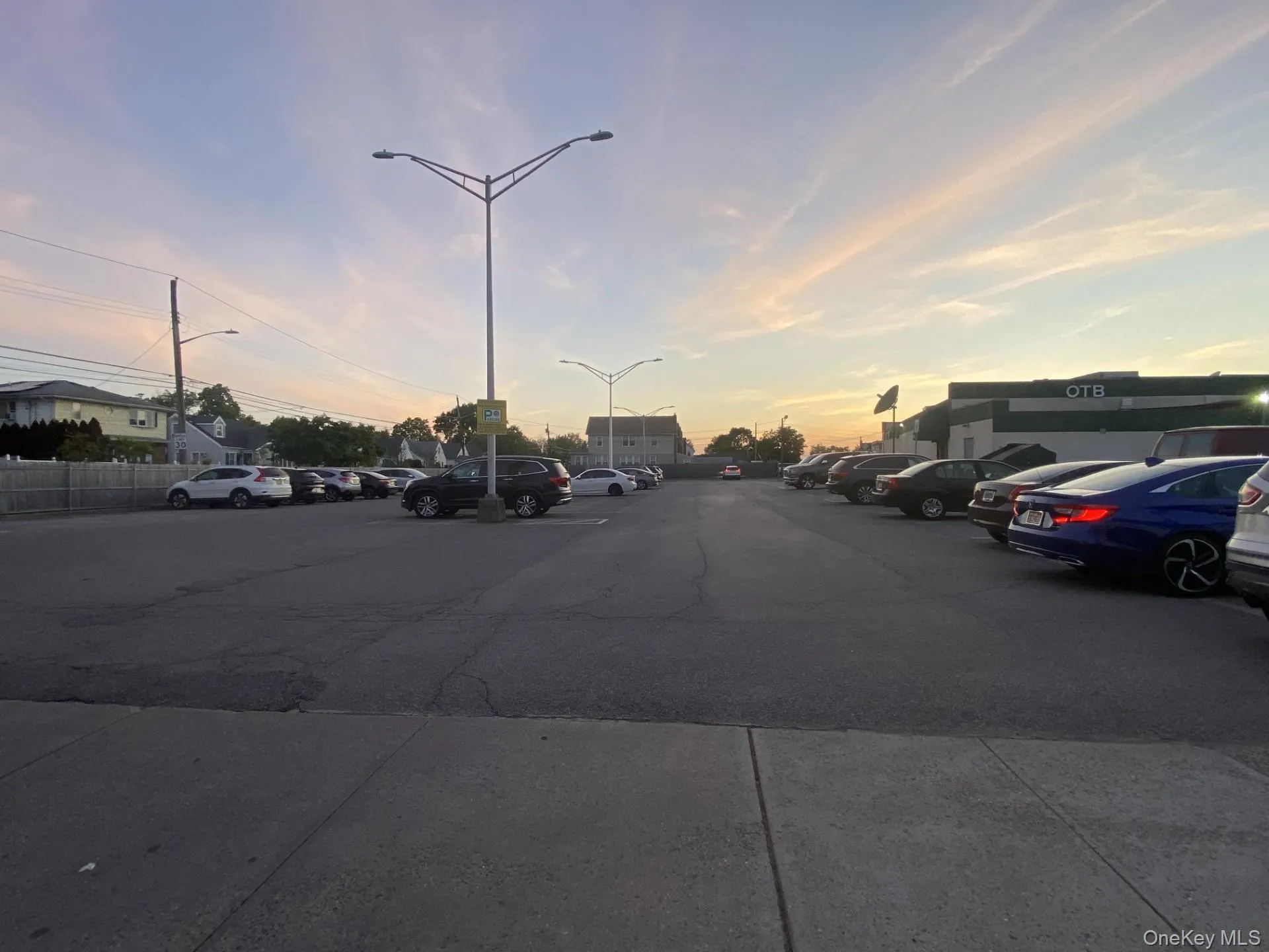 View of asphalt road with street lights View of asphalt road with street lights