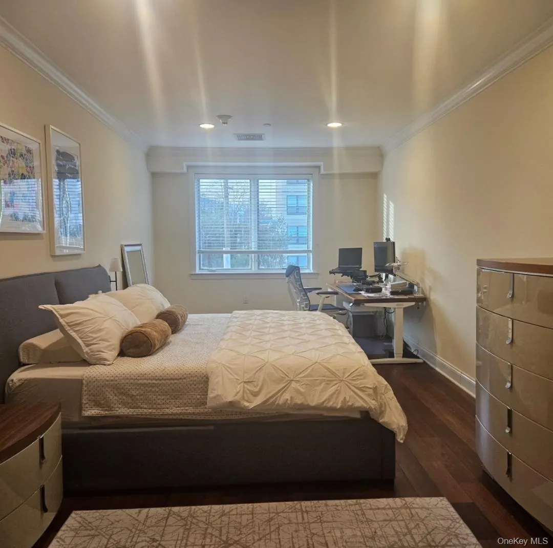 Bedroom with dark wood-type flooring, a desk, ornamental molding, and recessed lighting Bedroom with dark wood-type flooring, a desk, ornamental molding, and recessed lighting