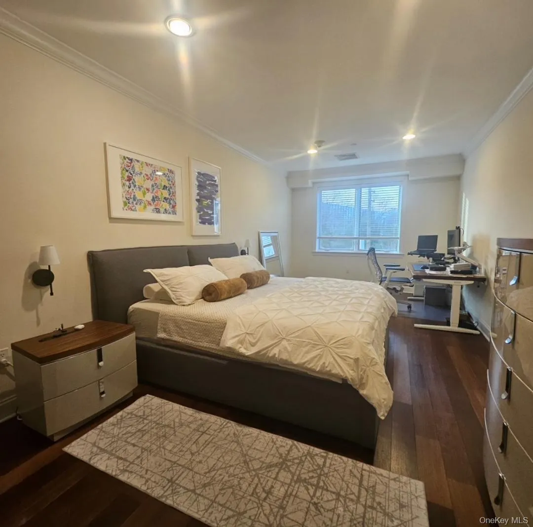 Bedroom featuring dark wood-style floors, ornamental molding, a desk, and recessed lighting Bedroom featuring dark wood-style floors, ornamental molding, a desk, and recessed lighting