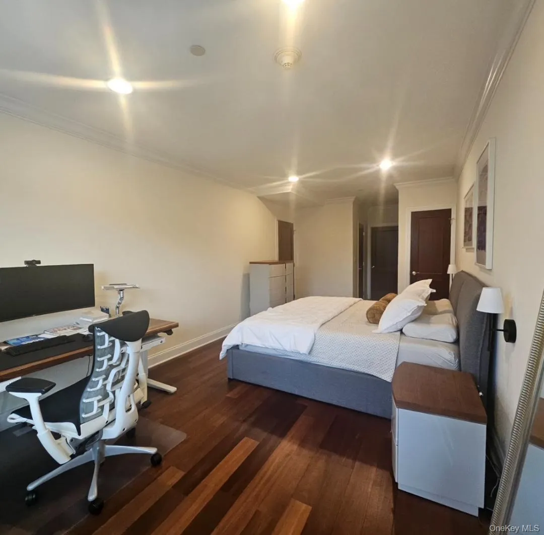 Bedroom featuring crown molding, dark wood-style flooring, an office area, and recessed lighting Bedroom featuring crown molding, dark wood-style flooring, an office area, and recessed lighting