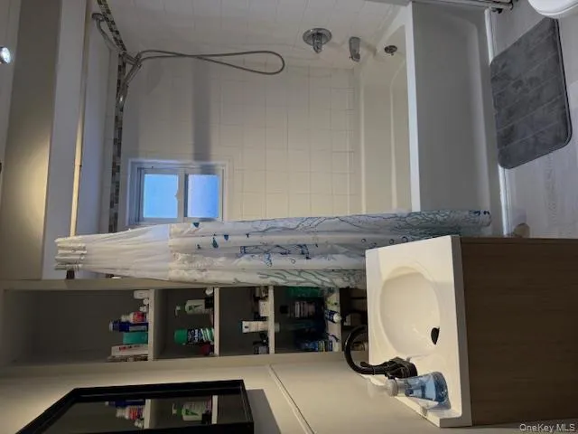 Bathroom featuring vanity and shower / bath combo Bathroom featuring vanity and shower / bath combo