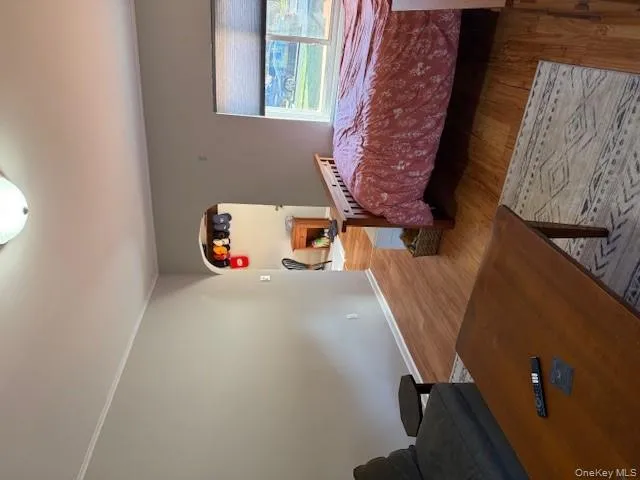 Living room with arched walkways and wood finished floors Living room with arched walkways and wood finished floors