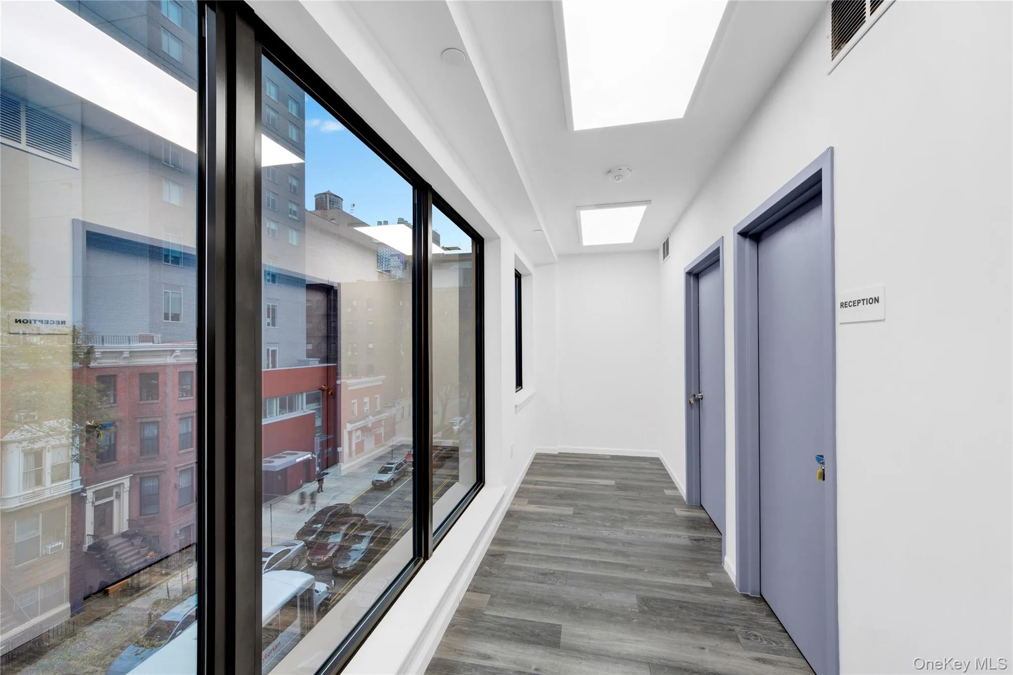 Hallway featuring wood finished floors Hallway featuring wood finished floors