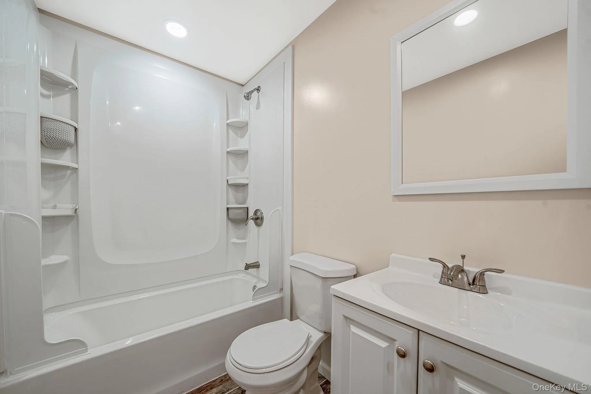 Bathroom with shower combination, vanity, and recessed lighting Bathroom with shower combination, vanity, and recessed lighting