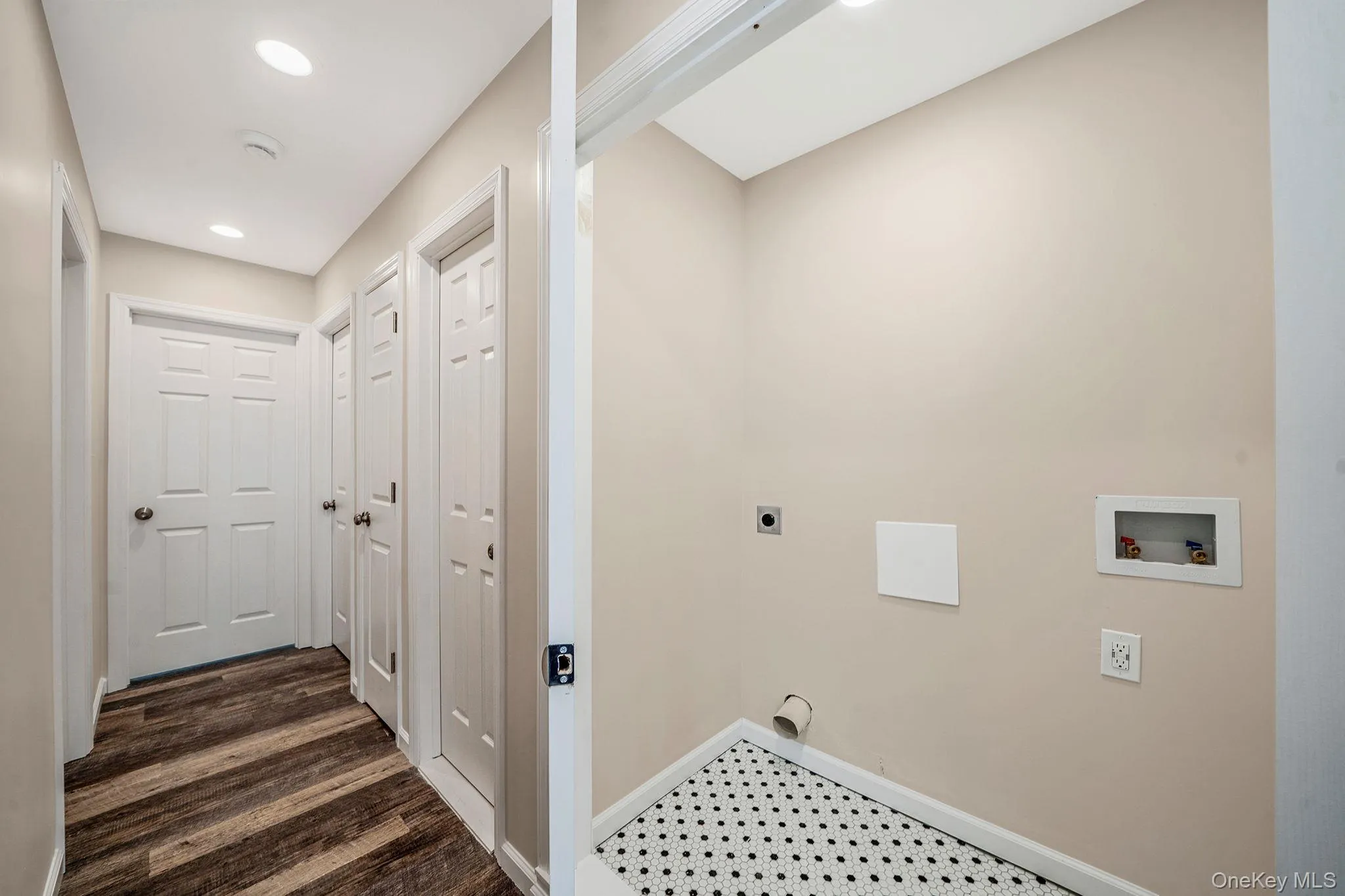 Laundry area with hookup for an electric dryer, recessed lighting, hookup for a washing machine, and dark flooring Laundry area with hookup for an electric dryer, recessed lighting, hookup for a washing machine, and dark flooring
