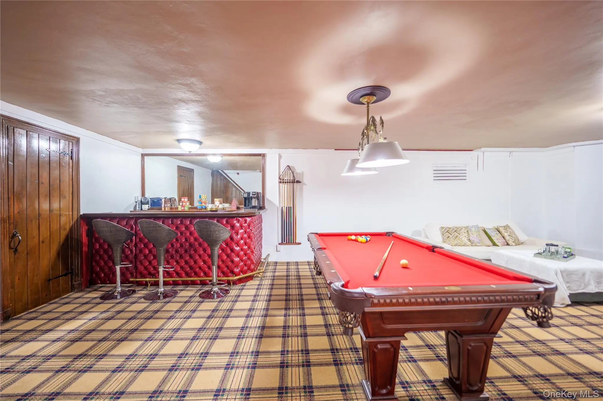 Game room with pool table, a dry bar, and carpet floors Game room with pool table, a dry bar, and carpet floors