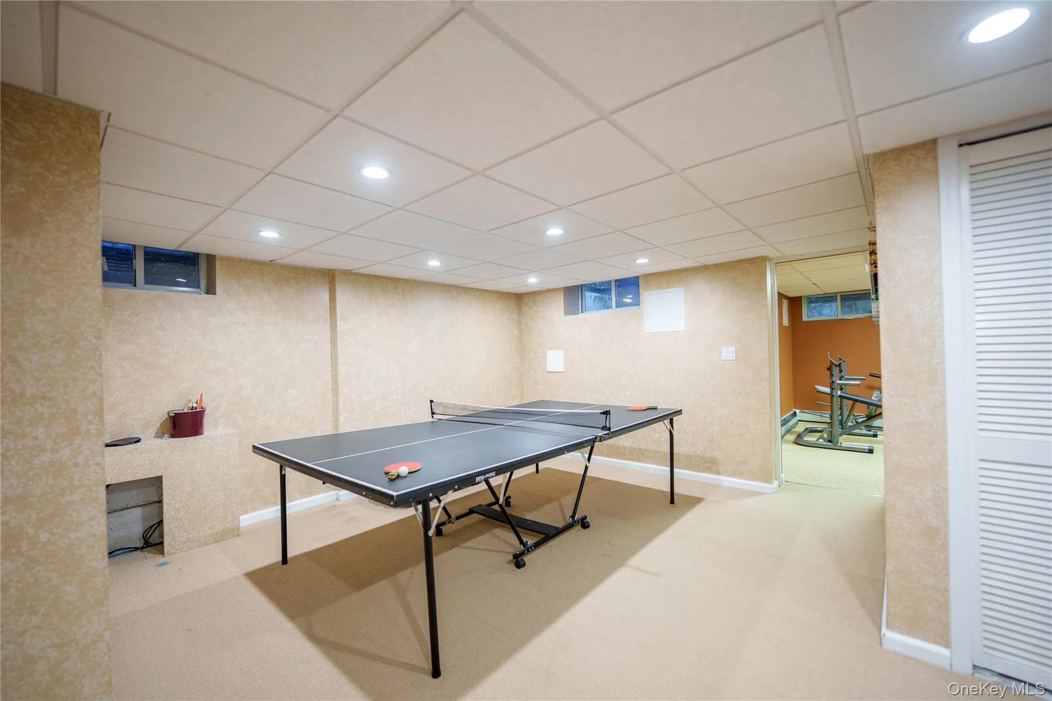 Game room with recessed lighting, carpet, and a drop ceiling Game room with recessed lighting, carpet, and a drop ceiling