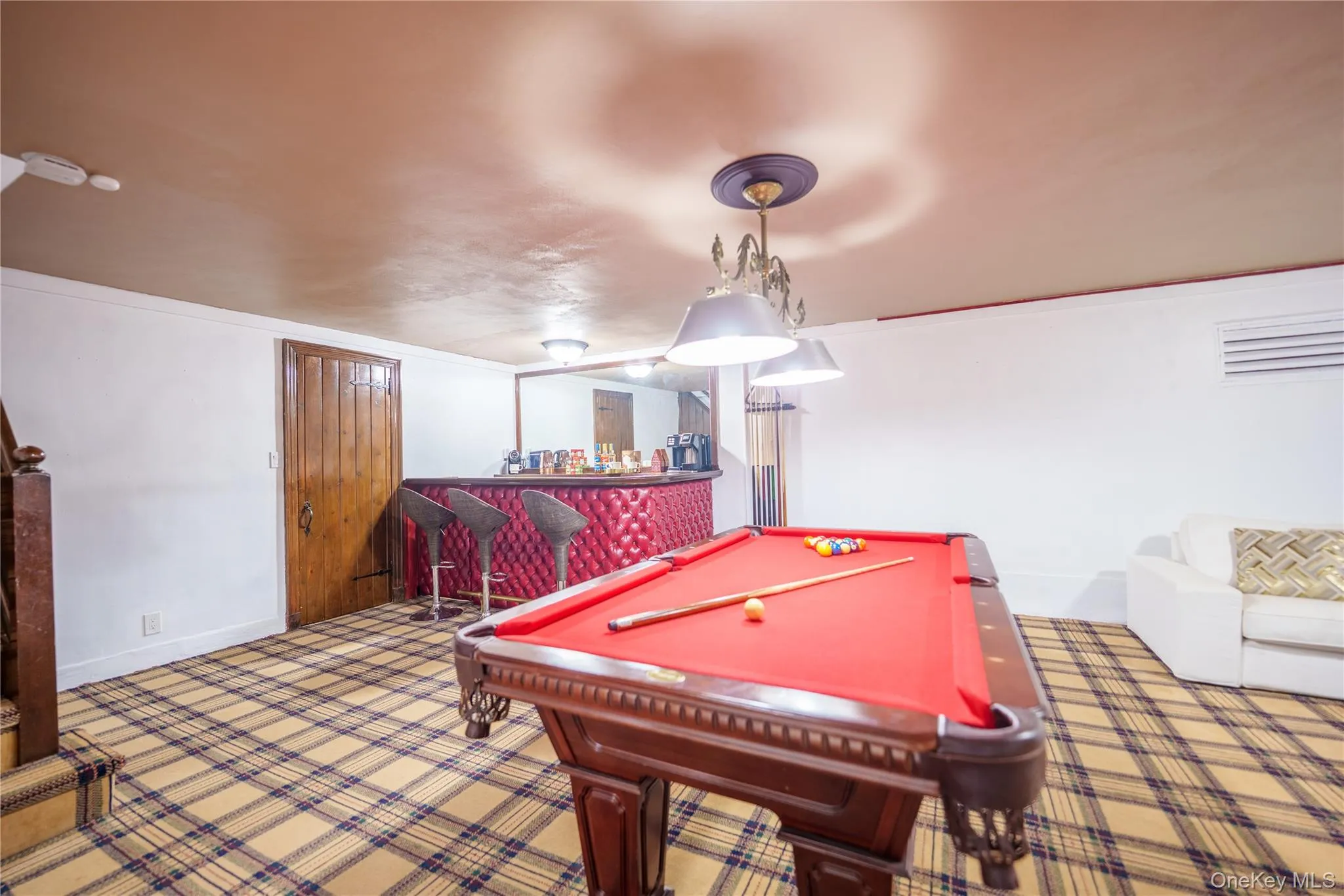 Lower Level Recreation area featuring pool table, laundry room is behind wood door on left. Facing wet bar Lower Level Recreation area featuring pool table, laundry room is behind wood door on left. Facing wet bar