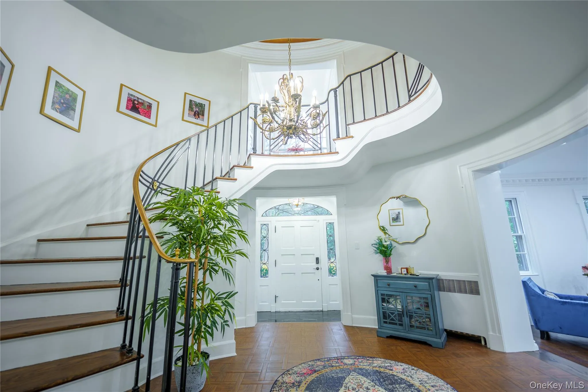 Entryway with a chandelier, a towering gold dome ceiling, circular stairway, with ornamental moldings Entryway with a chandelier, a towering gold dome ceiling, circular stairway, with ornamental moldings