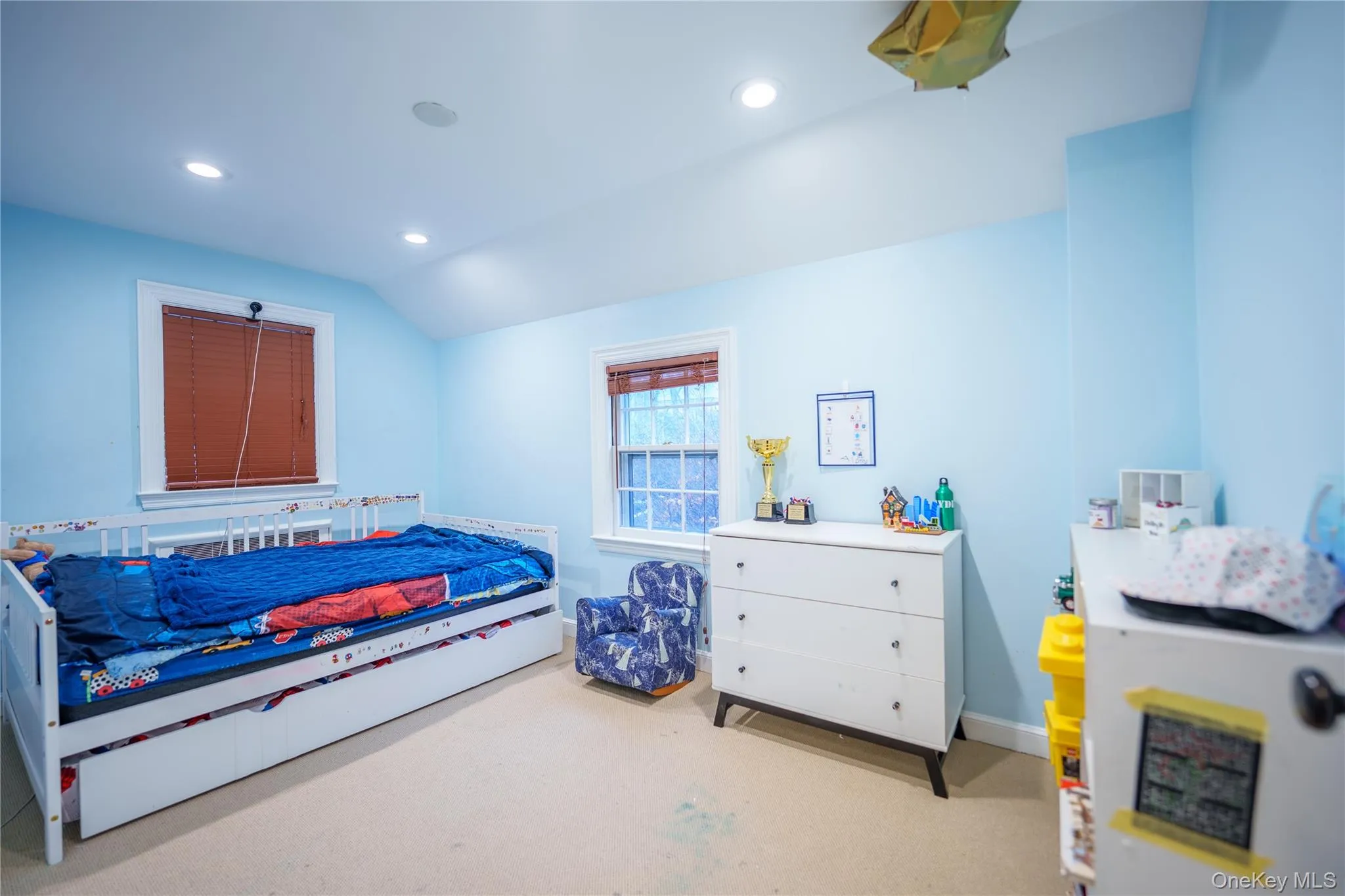 Down the hall are 2 more bedrooms. This one has light carpet, lofted ceiling, and recessed lighting Down the hall are 2 more bedrooms. This one has light carpet, lofted ceiling, and recessed lighting