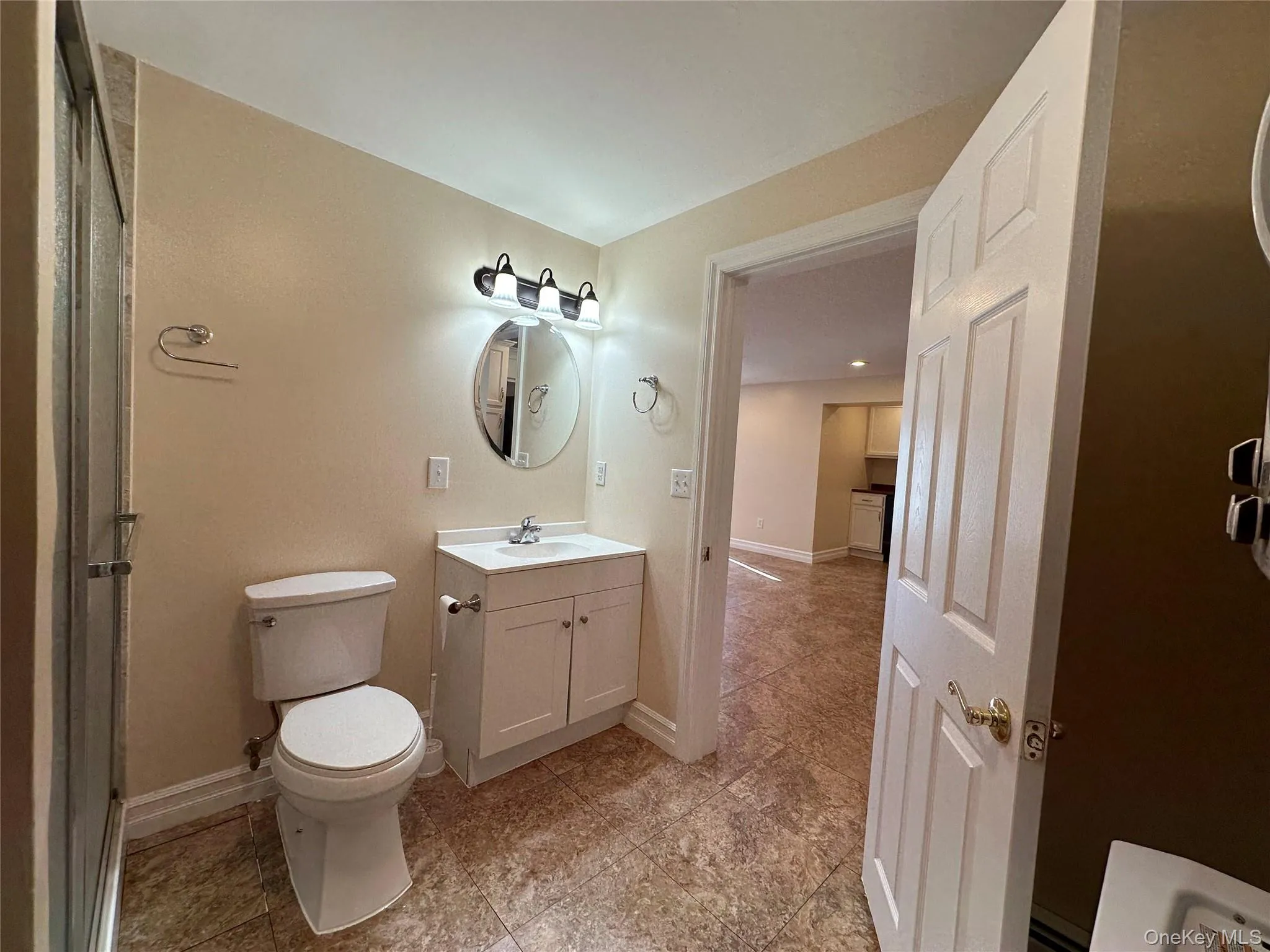 Full bathroom featuring vanity and a shower with door Full bathroom featuring vanity and a shower with door