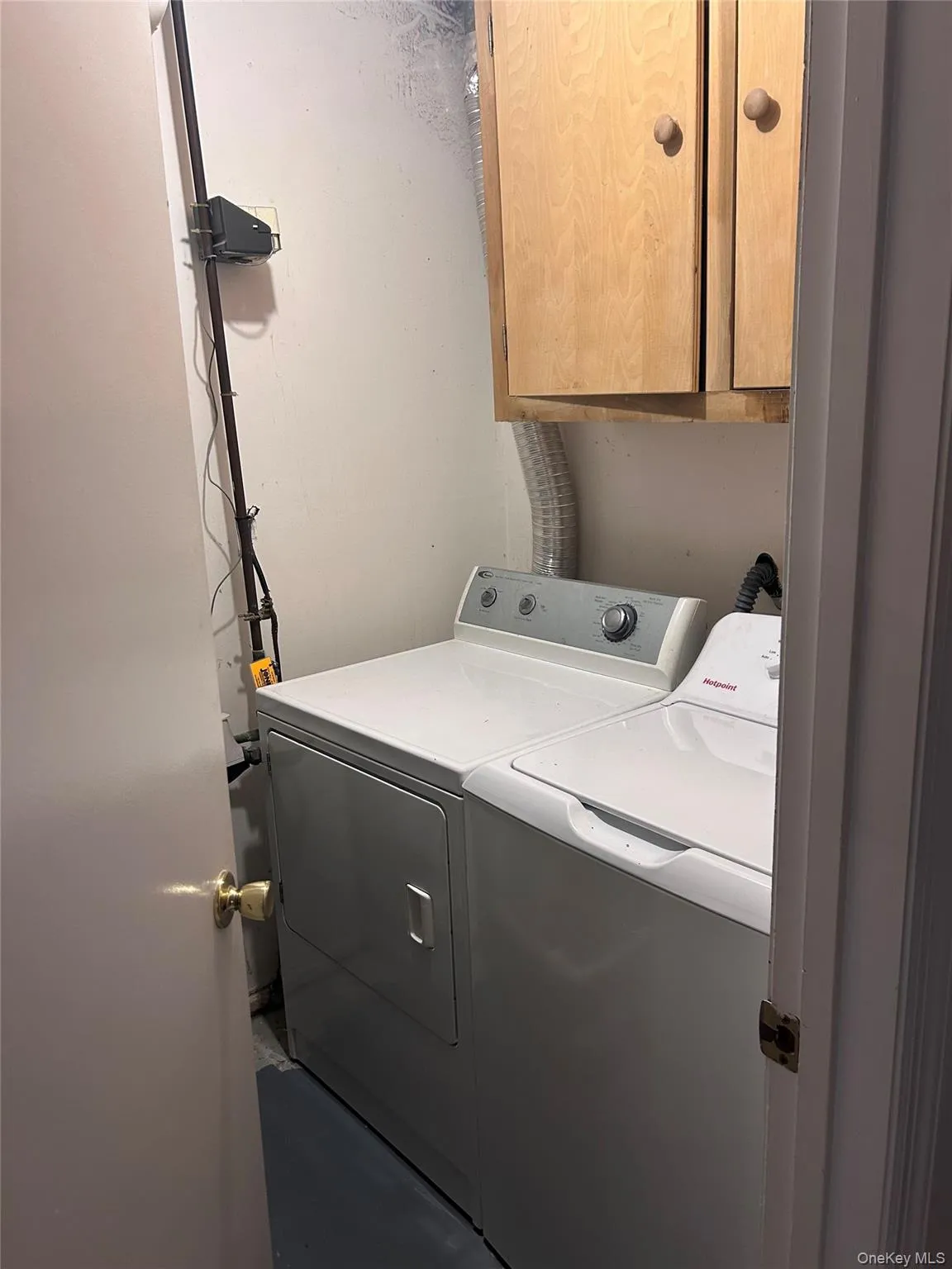 Laundry room featuring cabinet space and washing machine and clothes dryer Laundry room featuring cabinet space and washing machine and clothes dryer
