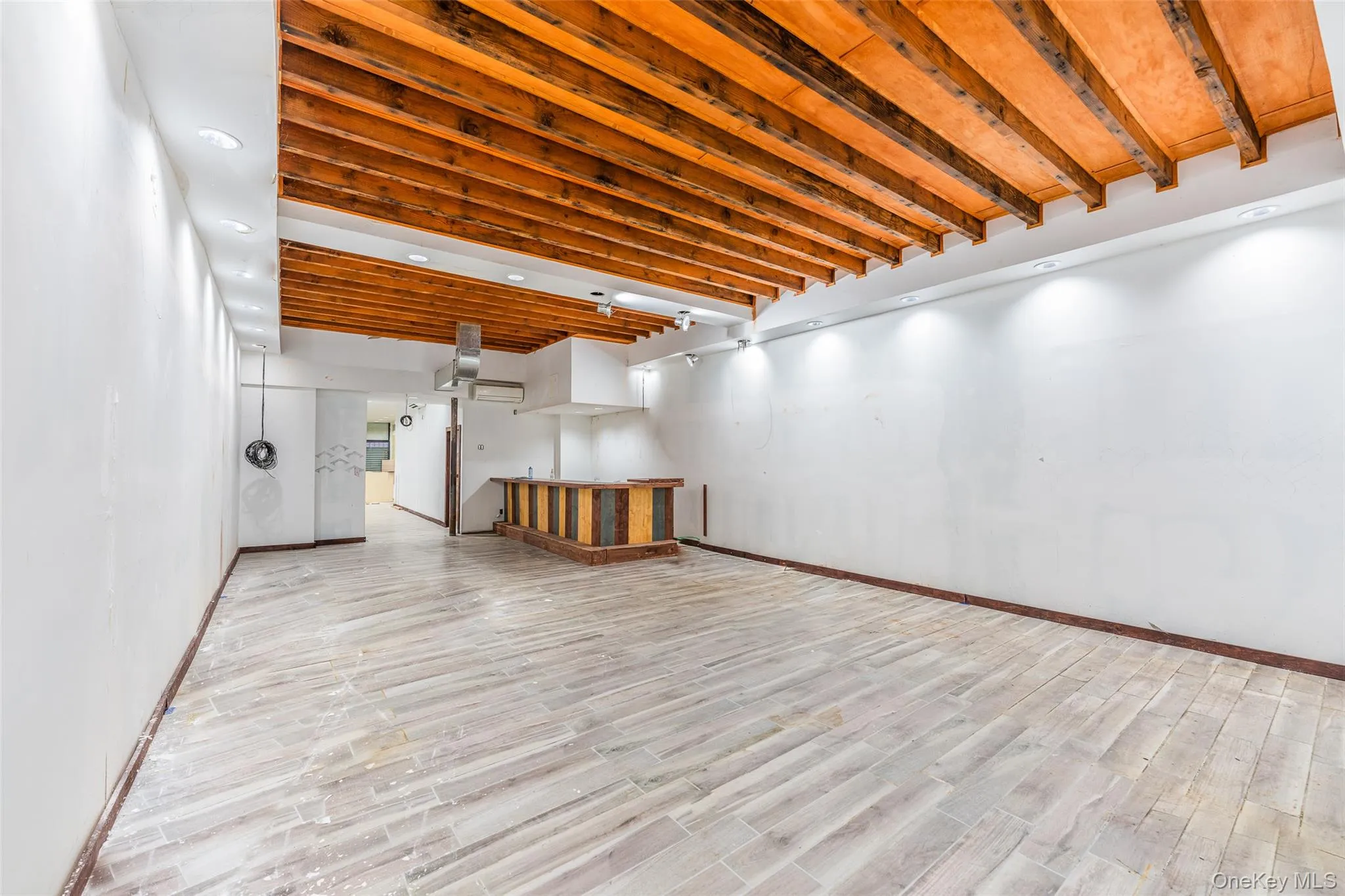 Finished basement with wood finish floors and recessed lighting Finished basement with wood finish floors and recessed lighting