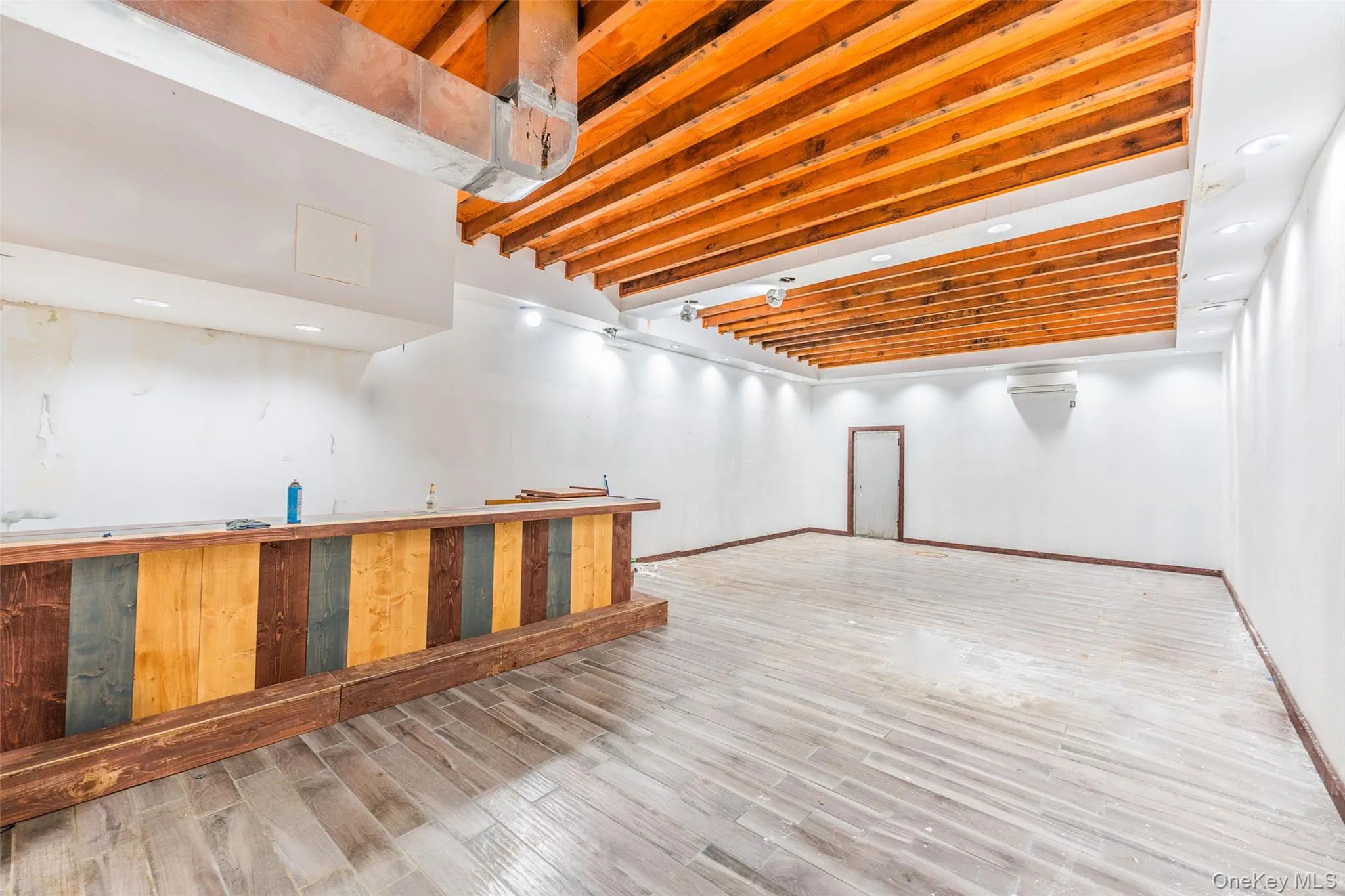 Finished basement featuring light wood-style flooring and recessed lighting Finished basement featuring light wood-style flooring and recessed lighting