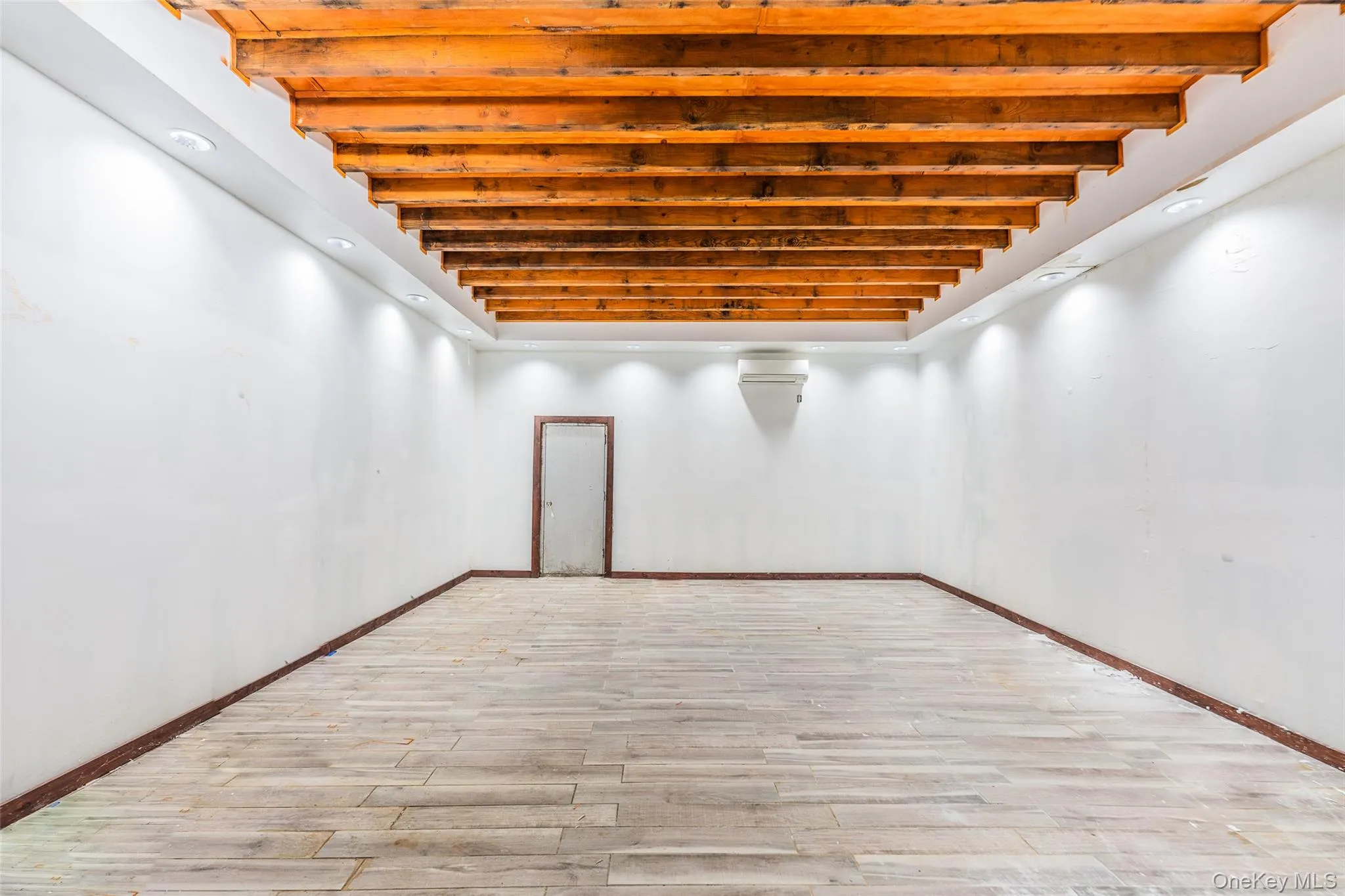 Basement with wood finished floors and recessed lighting Basement with wood finished floors and recessed lighting