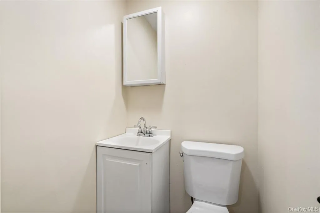Half bathroom with vanity and toilet Half bathroom with vanity and toilet
