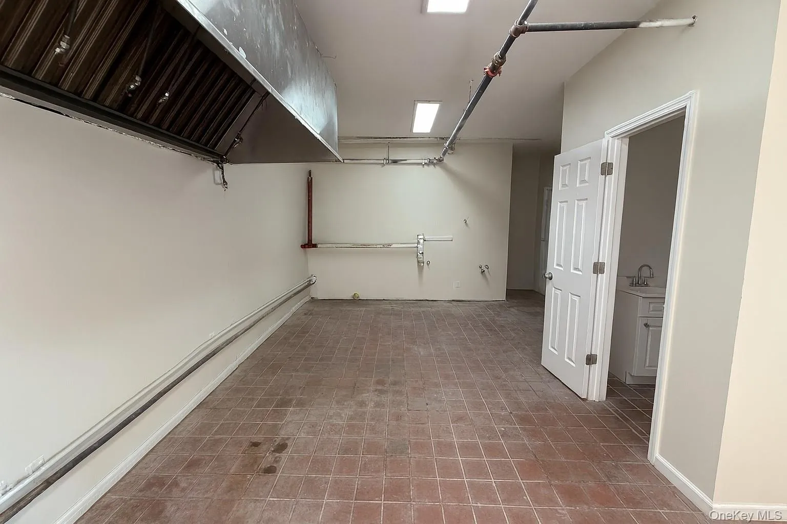 Below grade area featuring a garage and a sink Below grade area featuring a garage and a sink