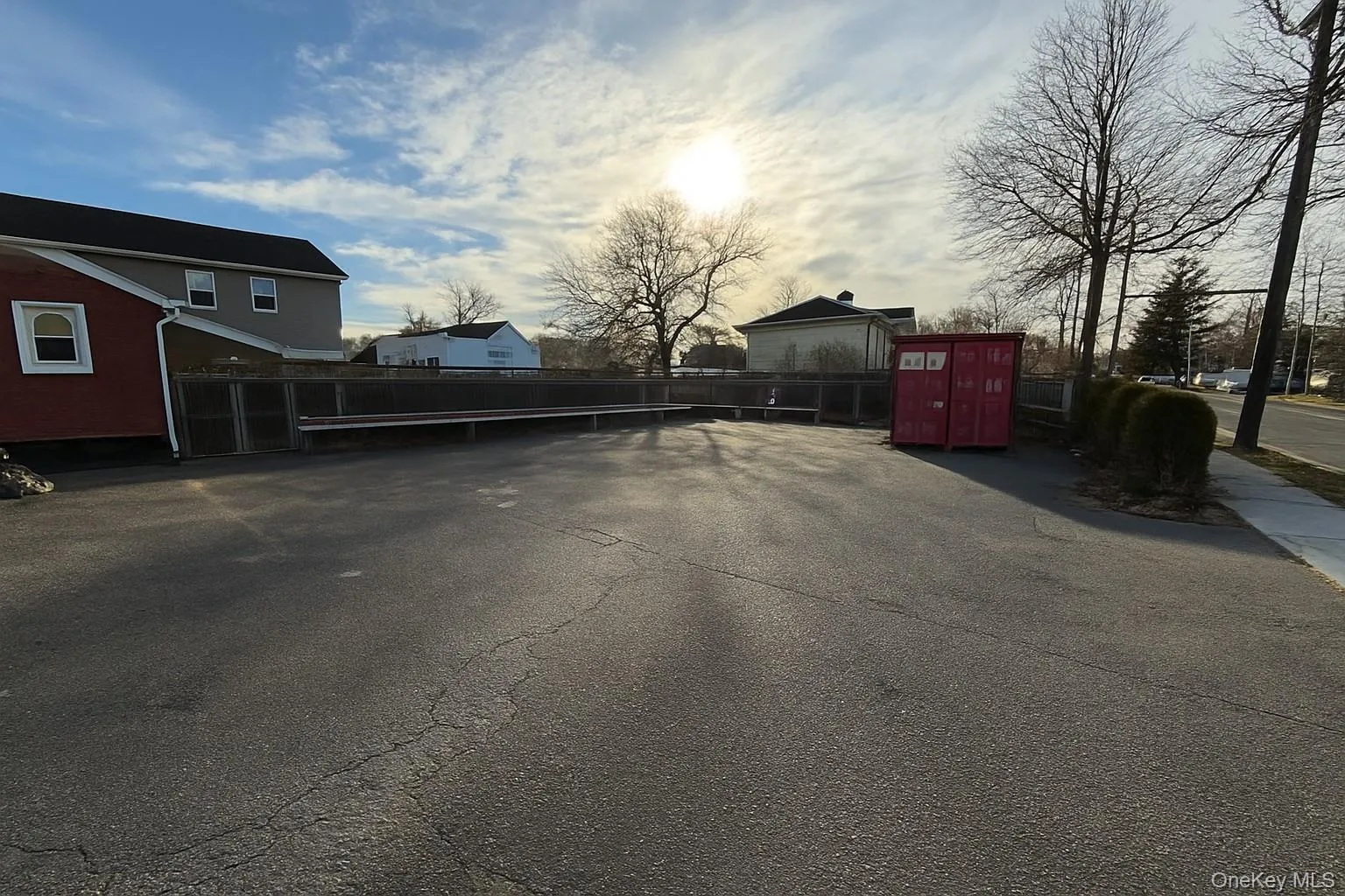View of parking featuring a gate View of parking featuring a gate