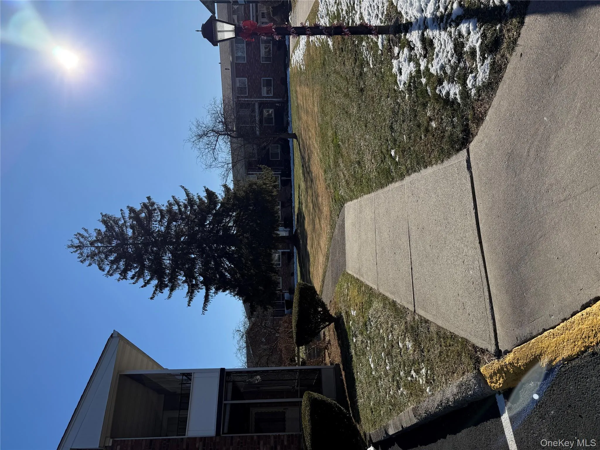 View of green lawn area and sidewalk to the condo View of green lawn area and sidewalk to the condo