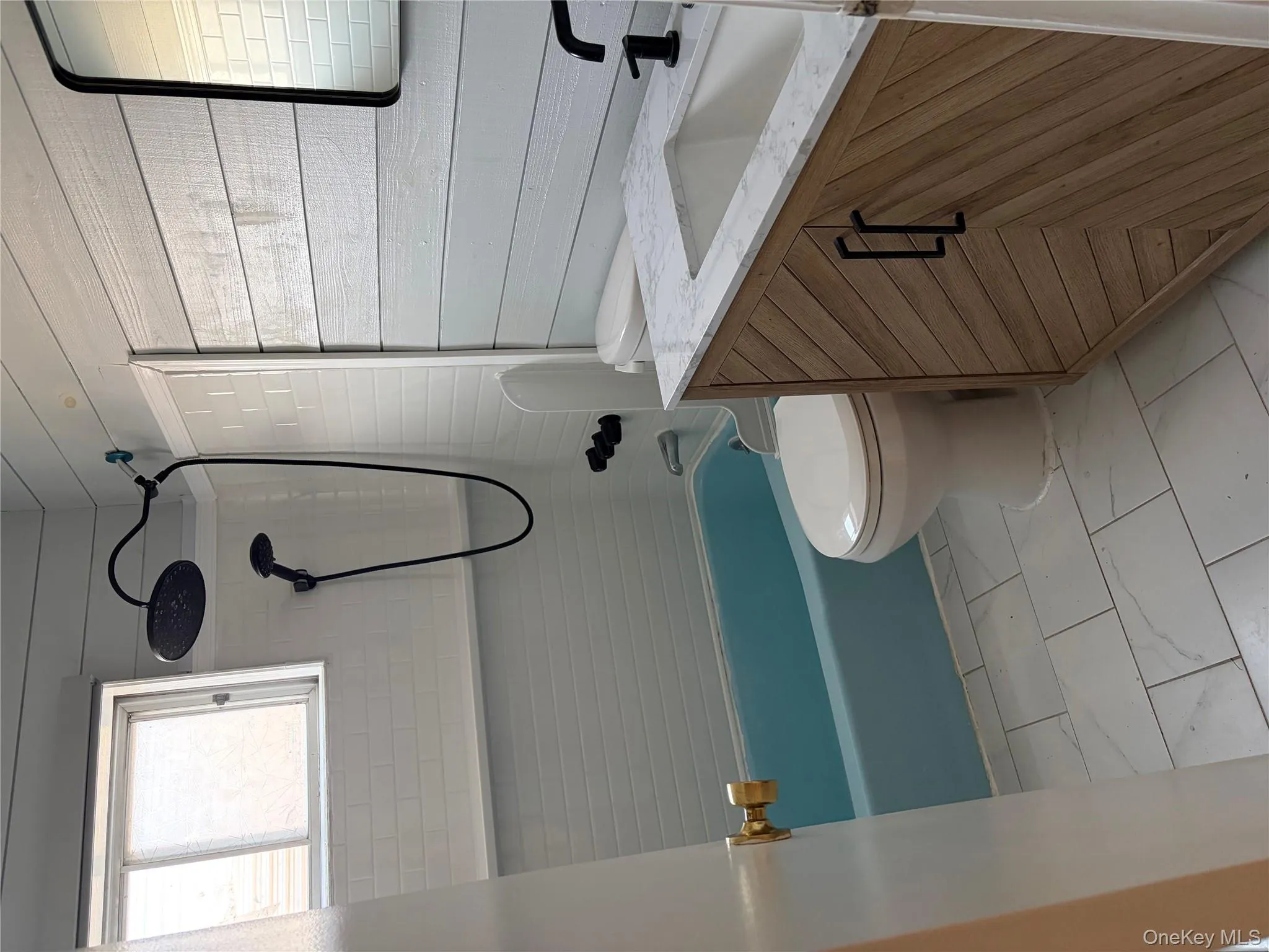 Full bath featuring shower / tub combination, vanity, and light marble finish floors Full bath featuring shower / tub combination, vanity, and light marble finish floors