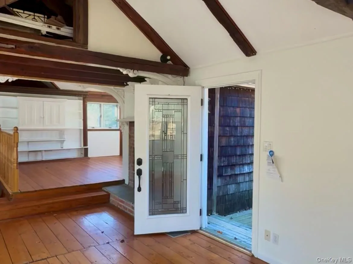 Doorway featuring hardwood / wood-style floors and arched walkways Doorway featuring hardwood / wood-style floors and arched walkways