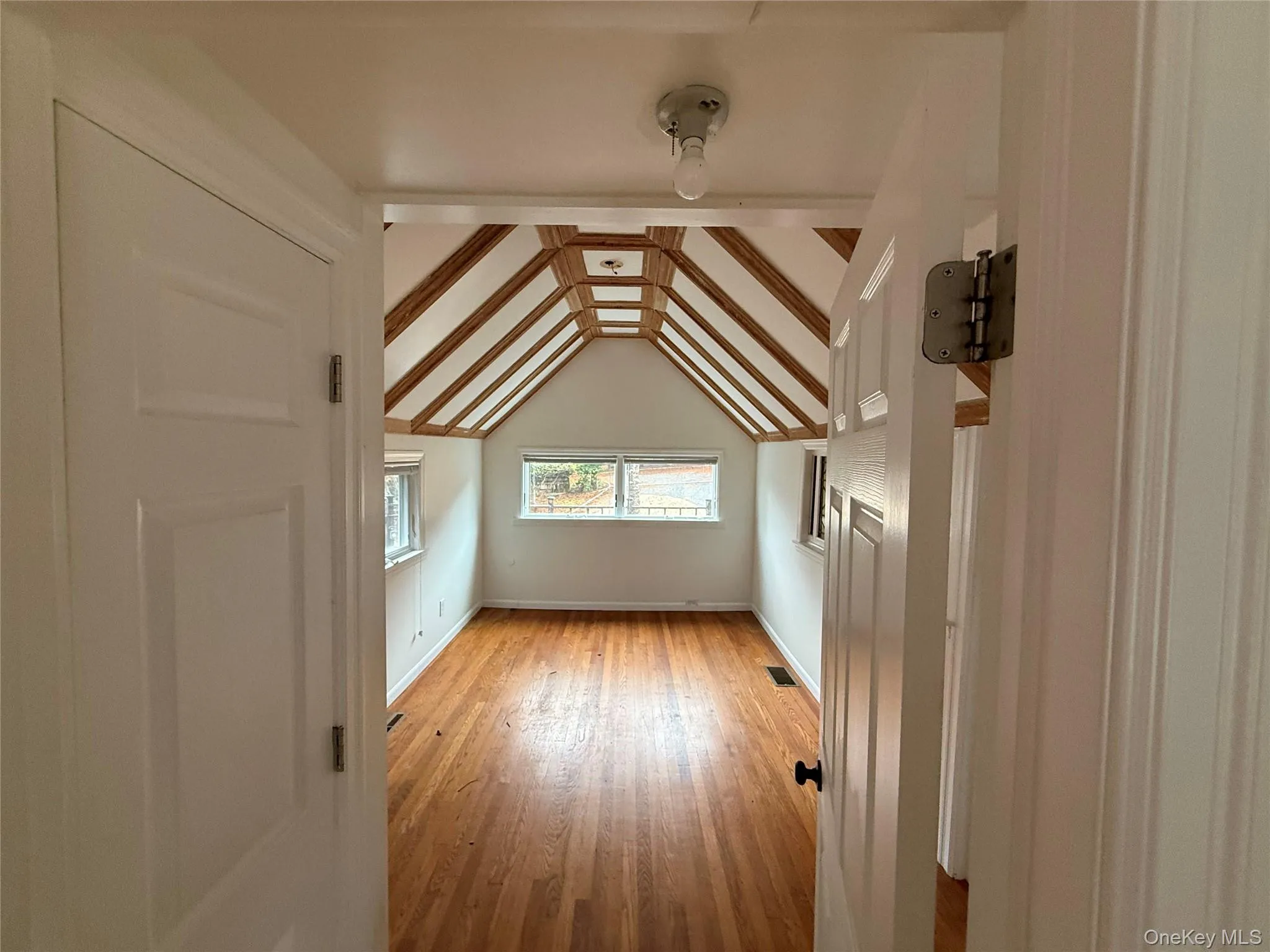 Bonus room featuring light wood-type flooring and baseboards Bonus room featuring light wood-type flooring and baseboards
