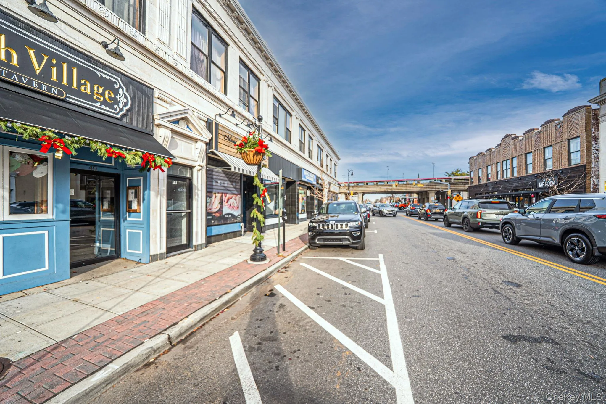 View of asphalt street with sidewalks, street lighting, and curbs View of asphalt street with sidewalks, street lighting, and curbs