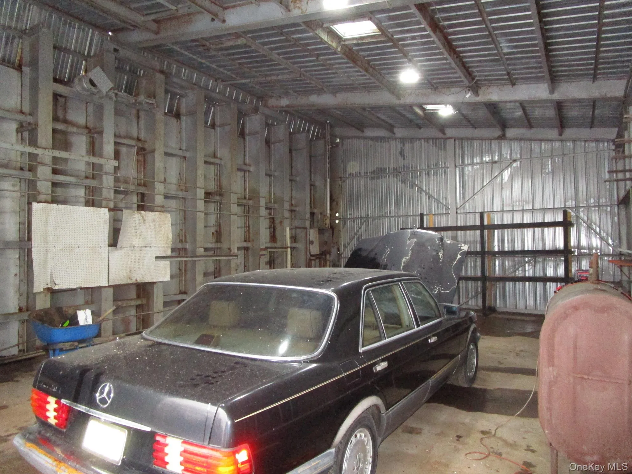 Garage featuring metal wall and oil tank Garage featuring metal wall and oil tank