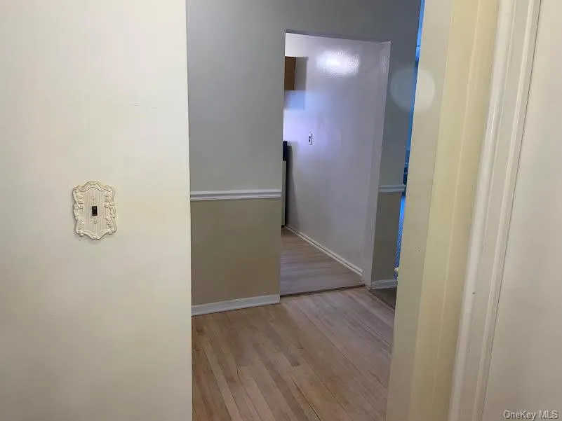 Corridor with light hardwood / wood-style floors Corridor with light hardwood / wood-style floors