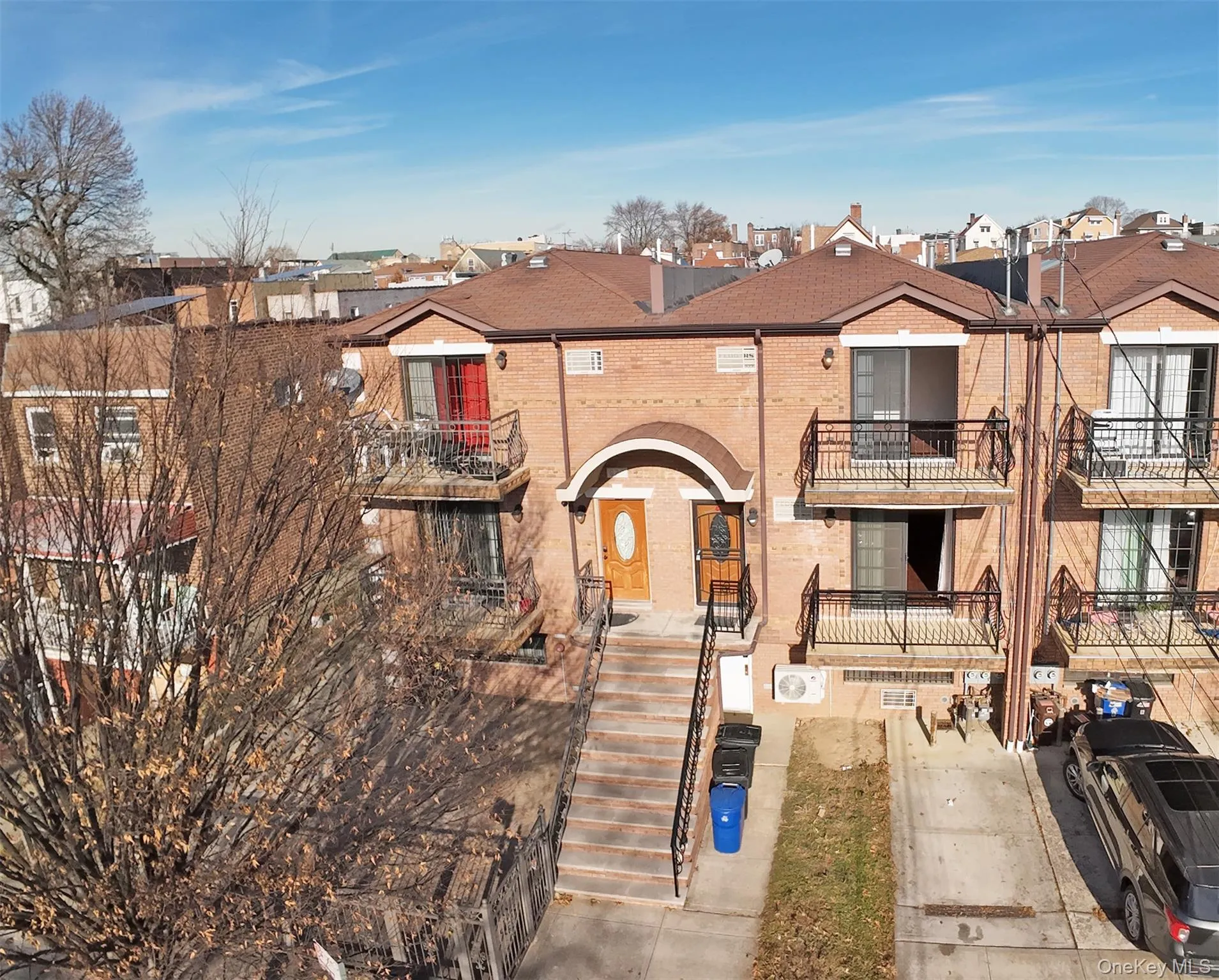 View of front of house with a balcony, brick siding, and a residential view View of front of house with a balcony, brick siding, and a residential view