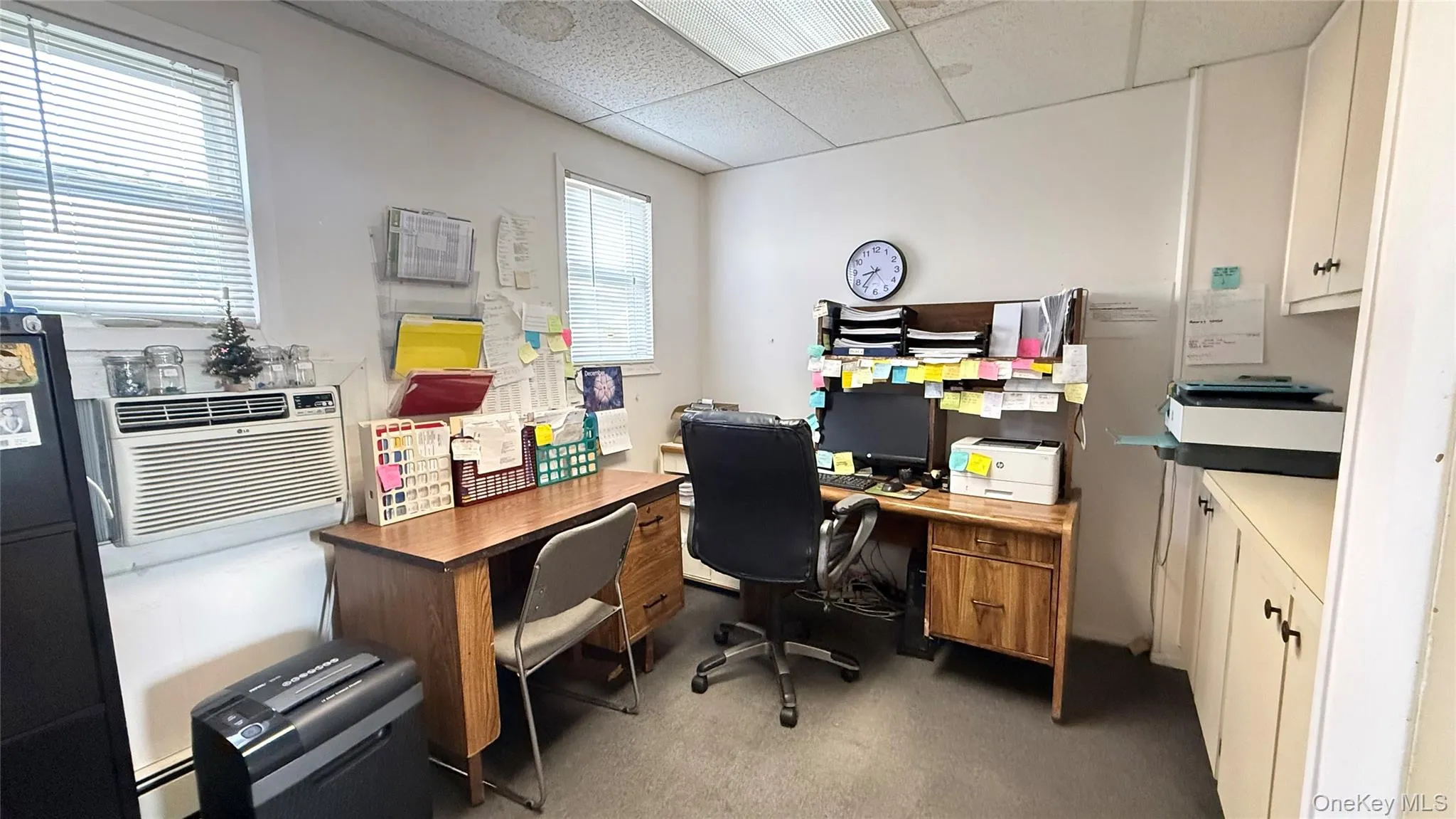 Home office with a drop ceiling and a baseboard radiator Home office with a drop ceiling and a baseboard radiator