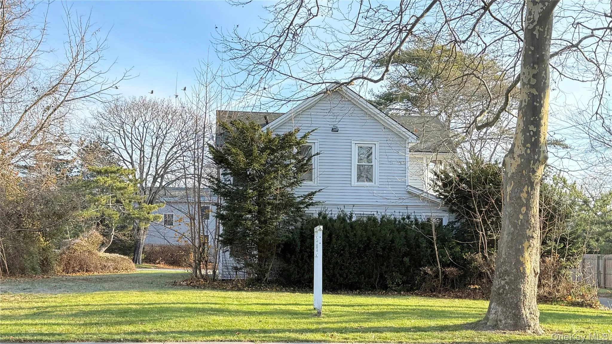 View of side of home featuring a lawn View of side of home featuring a lawn